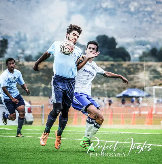 Soccer players challenging for a header
