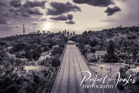Empty Los Angeles freeway leading toward downtown skyline