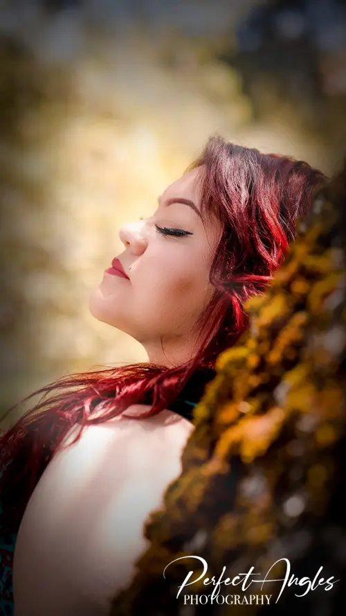 Portrait of a woman with red hair in golden light
